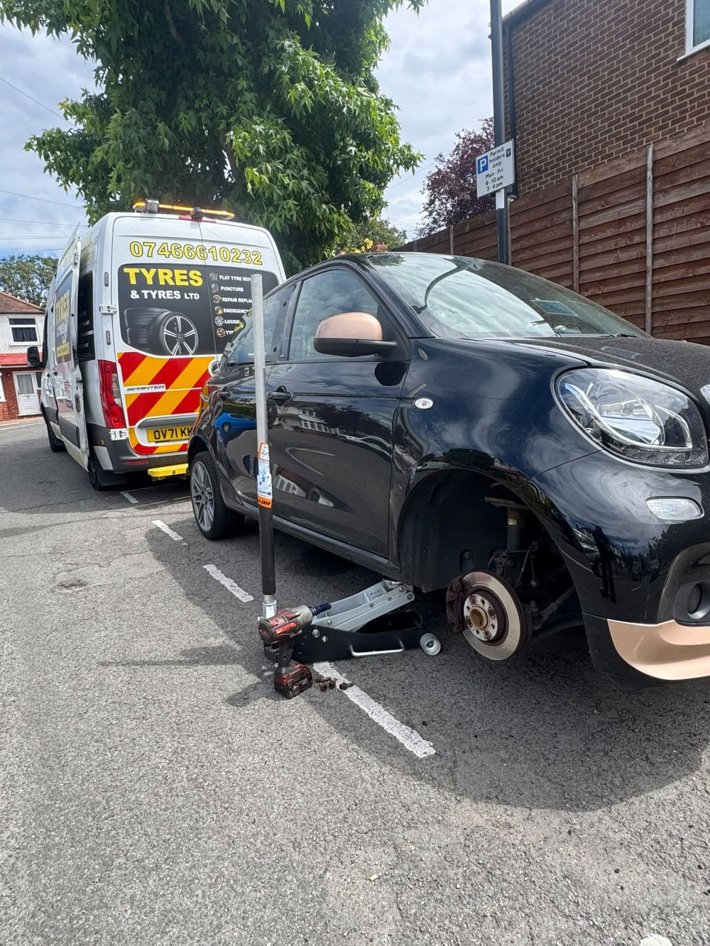 Roadside mobile tyre fitting van replacing flat tyre on site