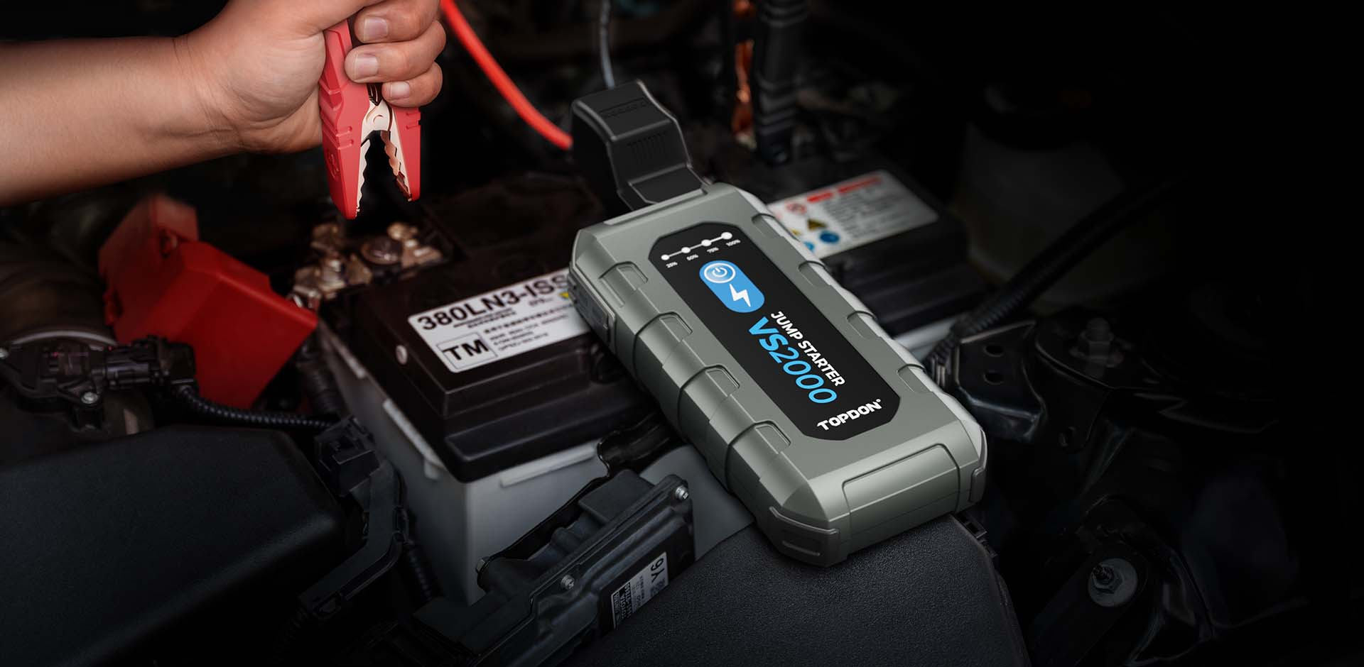 Car with hood open at night needing jumpstart